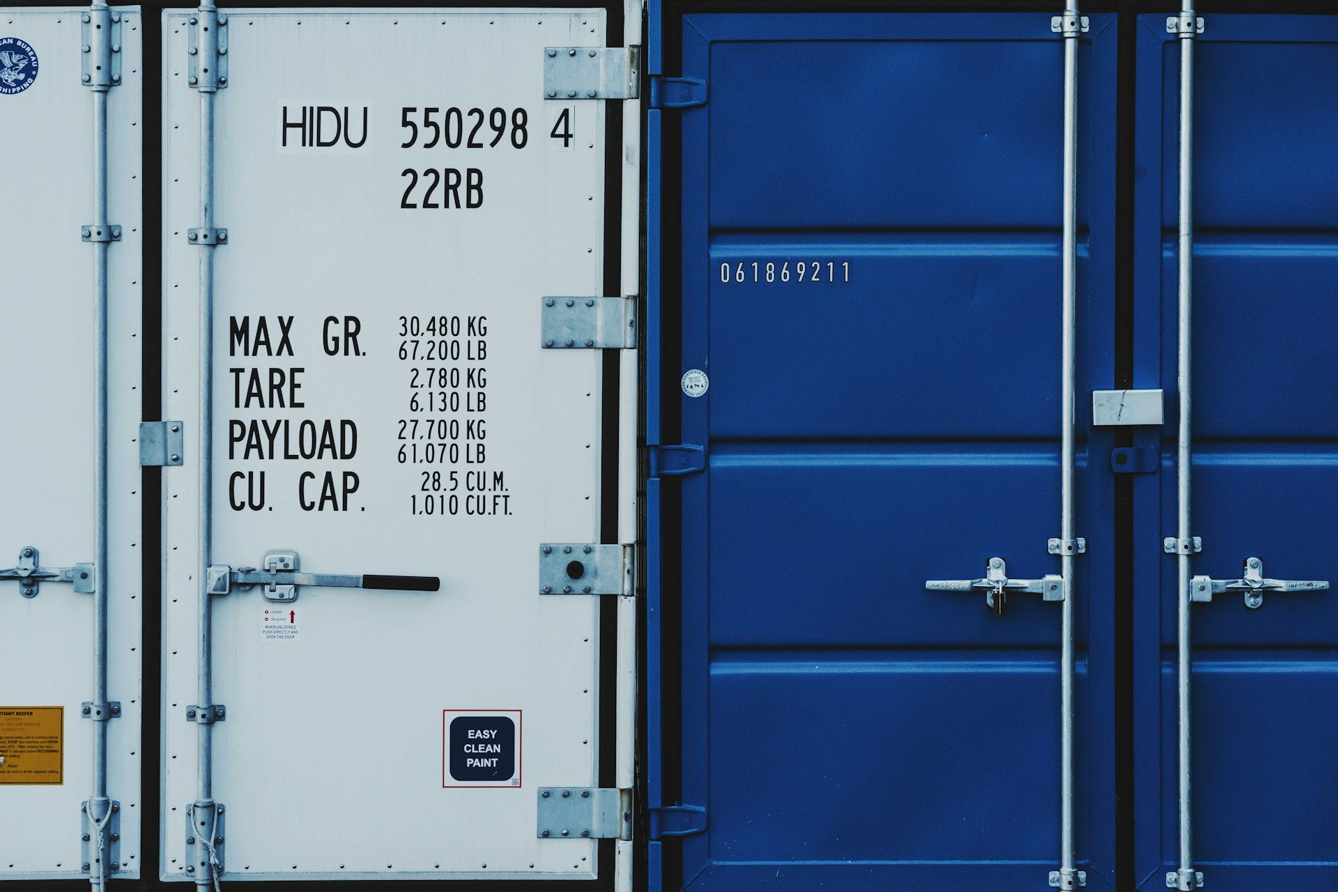 a couple of blue and white shipping containers